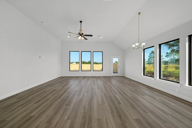 unfurnished living room with ceiling fan with notable chandelier, vaulted ceiling, and hardwood / wood-style flooring