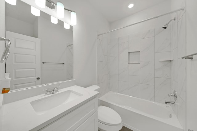 full bathroom with vanity, tiled shower / bath combo, and toilet