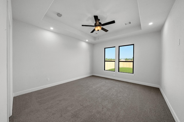 801 Rd 5812, Cleveland, TX 77327 - unfurnished room with a tray ceiling, recessed lighting, dark colored carpet, a ceiling fan, and baseboards