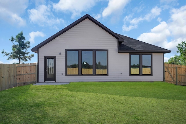 back of house featuring a lawn