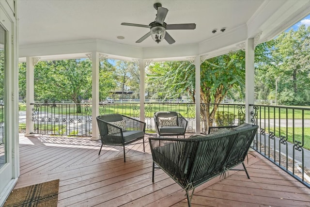 sunroom / solarium featuring ceiling fan