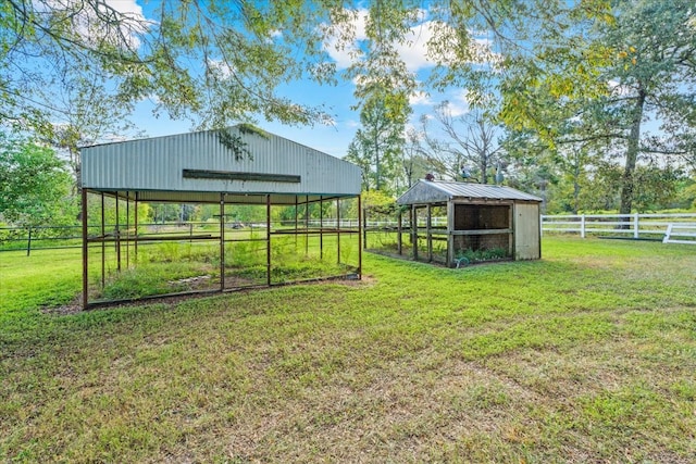 view of yard featuring a rural view and an outbuilding