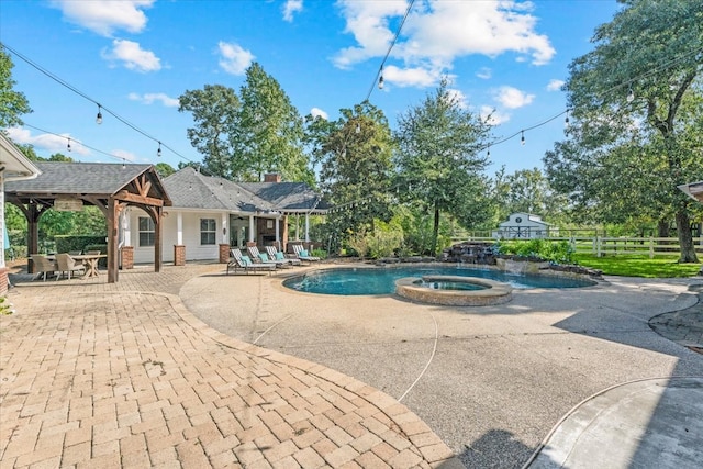 view of pool featuring an in ground hot tub and a patio area