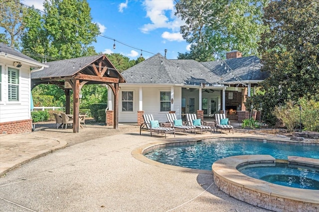 view of pool with an in ground hot tub, a gazebo, a patio, and ceiling fan