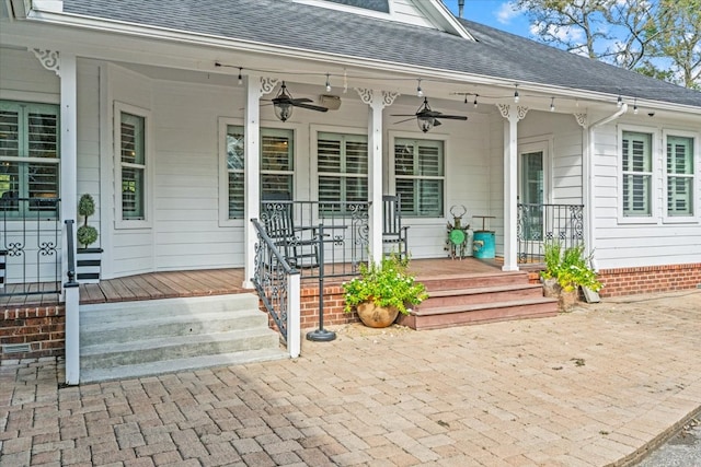 doorway to property featuring ceiling fan and a porch