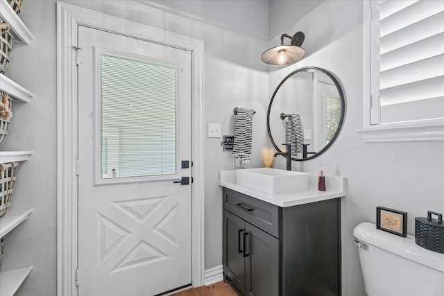 bathroom featuring hardwood / wood-style floors, vanity, and toilet