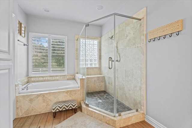 bathroom featuring separate shower and tub and wood-type flooring