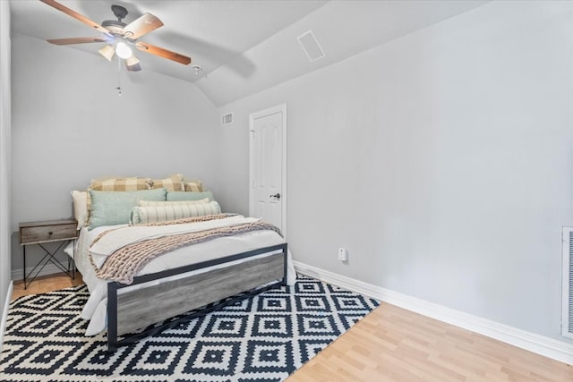 bedroom with lofted ceiling, ceiling fan, and wood-type flooring