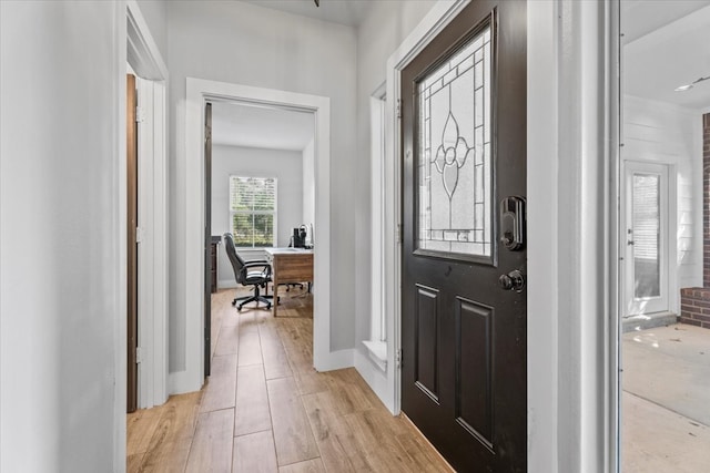 foyer entrance with light hardwood / wood-style flooring