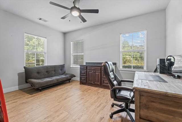 office area with light wood-type flooring and ceiling fan