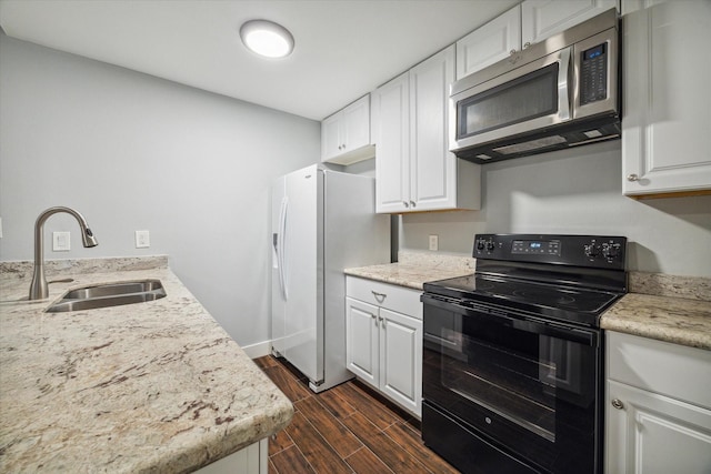 kitchen with white cabinetry, sink, white fridge with ice dispenser, and black range with electric cooktop