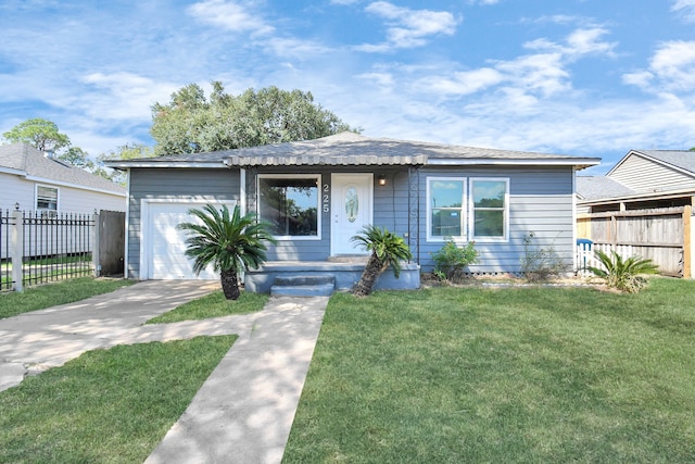 view of front of home with a front lawn and a garage