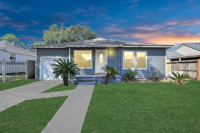 ranch-style home with a lawn and a garage