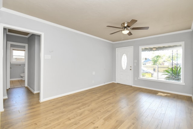 foyer entrance with ornamental molding, ceiling fan, light hardwood / wood-style flooring, and a wealth of natural light