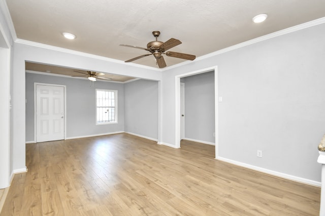 unfurnished room featuring light wood-type flooring, ceiling fan, and crown molding