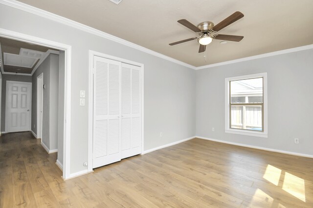 unfurnished bedroom featuring ceiling fan, light wood-type flooring, and crown molding