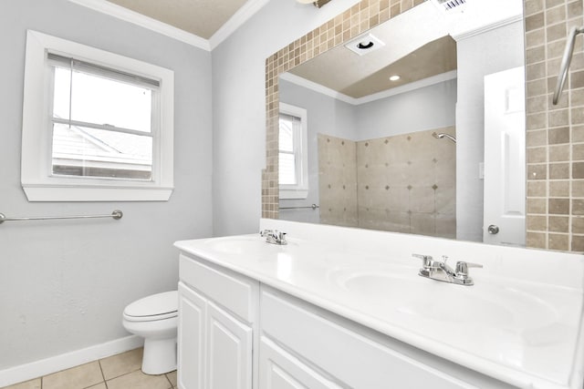 225 N Carolina St, Houston, TX 77029 - bathroom featuring ornamental molding, double vanity, tile patterned flooring, toilet, and baseboards