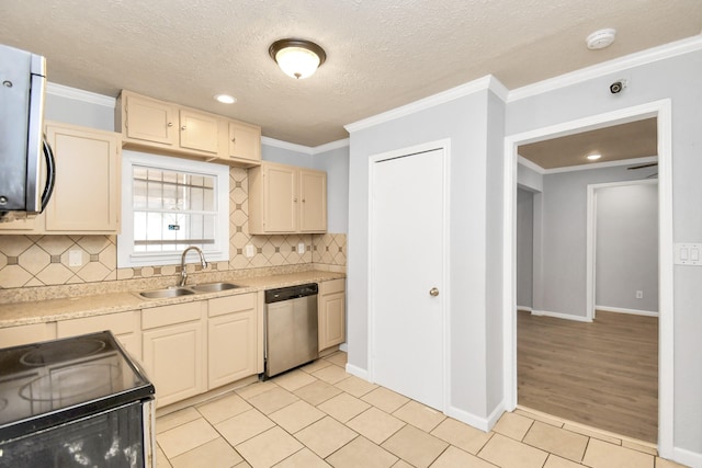 225 N Carolina St, Houston, TX 77029 - kitchen featuring stainless steel appliances, a sink, light tile patterned floors, tasteful backsplash, and crown molding