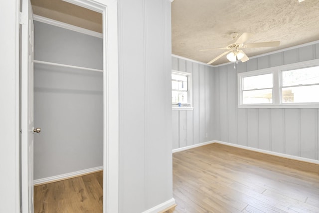 225 N Carolina St, Houston, TX 77029 - unfurnished bedroom with wood finished floors, baseboards, ornamental molding, and ceiling fan