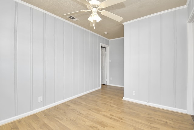 unfurnished room with a textured ceiling, light hardwood / wood-style floors, ceiling fan, and crown molding