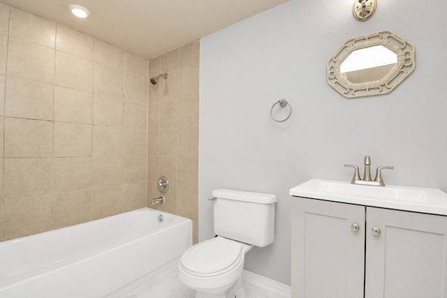 full bathroom with vanity, tiled shower / bath, and toilet