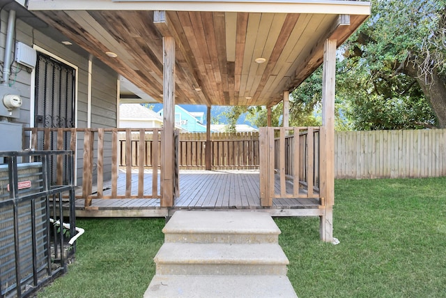 wooden terrace featuring a lawn