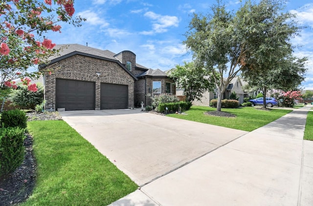 view of front of house featuring a garage and a front lawn