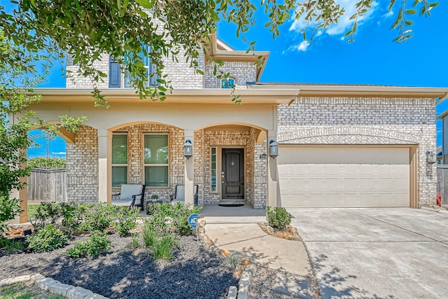 view of front of property with a garage and covered porch