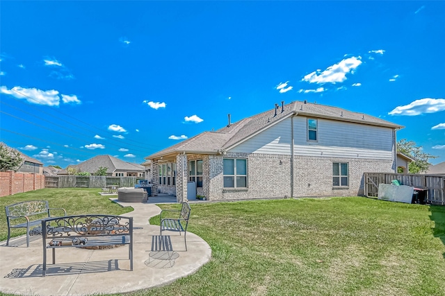 rear view of house featuring a yard and a patio area