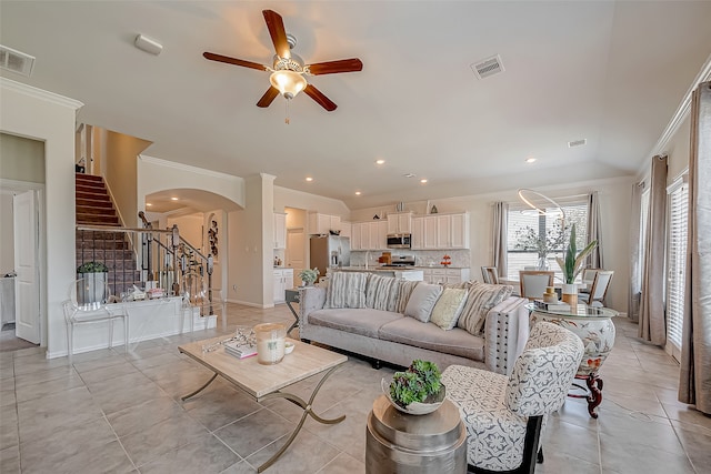 living room with ceiling fan, light tile patterned floors, and crown molding