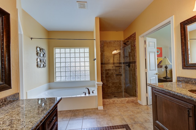 bathroom featuring tile patterned floors, vanity, and shower with separate bathtub