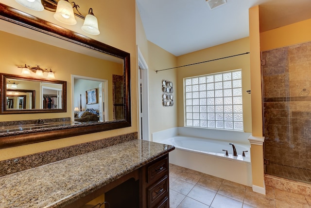 bathroom with tile patterned flooring, vanity, and shower with separate bathtub