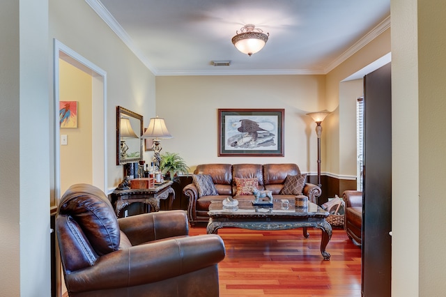 living room featuring crown molding and hardwood / wood-style flooring