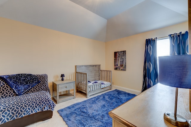 bedroom featuring carpet flooring and vaulted ceiling