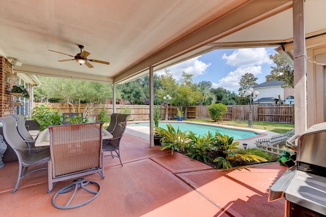 view of patio / terrace with a fenced in pool, area for grilling, and ceiling fan