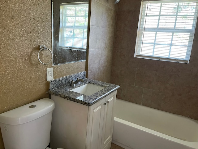 full bathroom with vanity, toilet, and tiled shower / bath