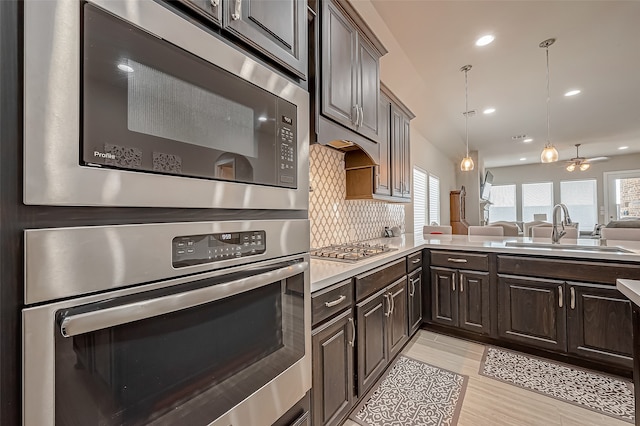 kitchen with appliances with stainless steel finishes, plenty of natural light, sink, and tasteful backsplash