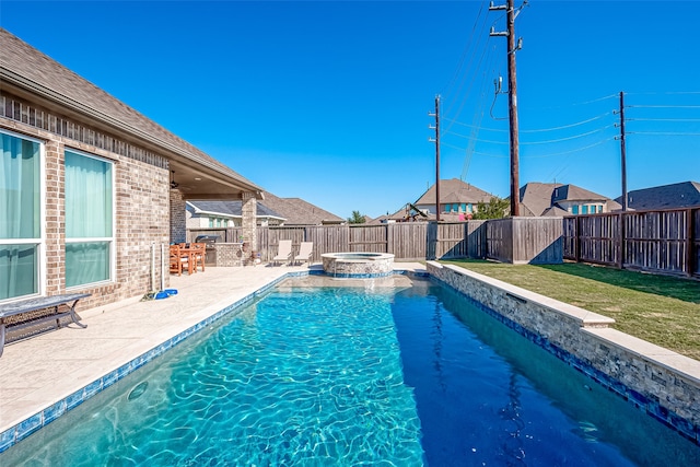 view of swimming pool featuring a lawn, an in ground hot tub, and a patio area