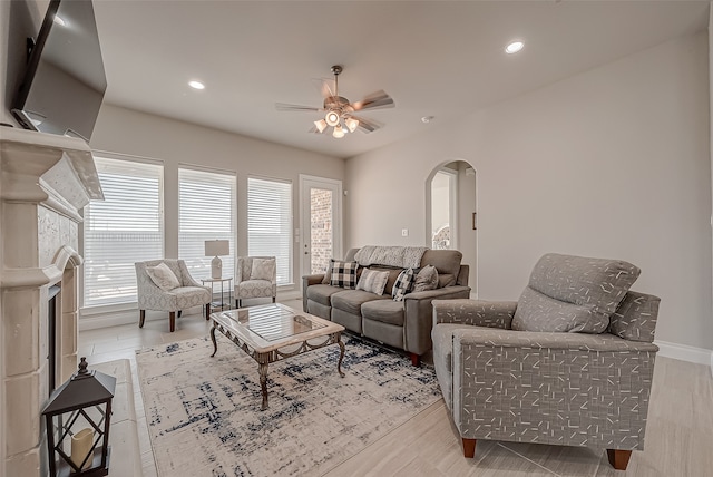 living room with ceiling fan and light hardwood / wood-style floors