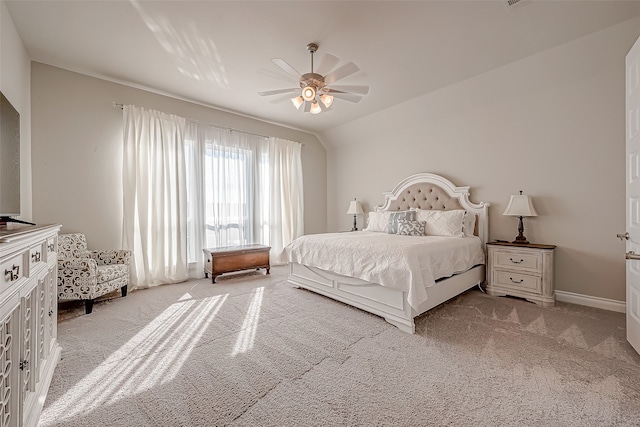 carpeted bedroom featuring lofted ceiling and ceiling fan