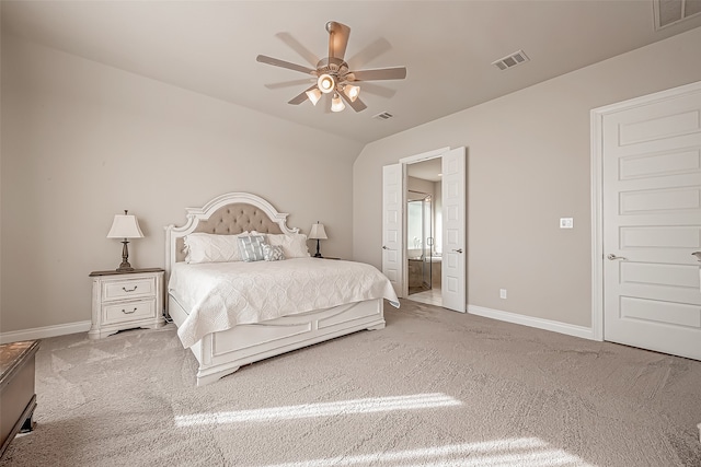 bedroom featuring ceiling fan, ensuite bath, and carpet flooring