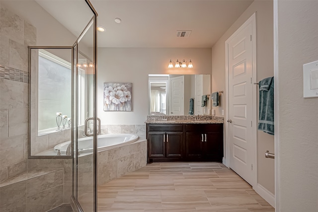 bathroom with plus walk in shower and vanity