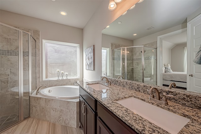 bathroom with independent shower and bath and vanity