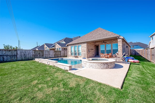 view of swimming pool featuring a patio, an in ground hot tub, and a yard