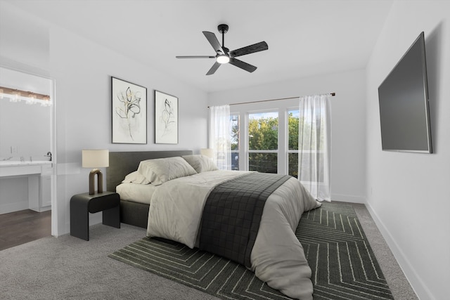 carpeted bedroom with connected bathroom and ceiling fan