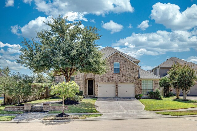 view of front facade with a front yard and a garage