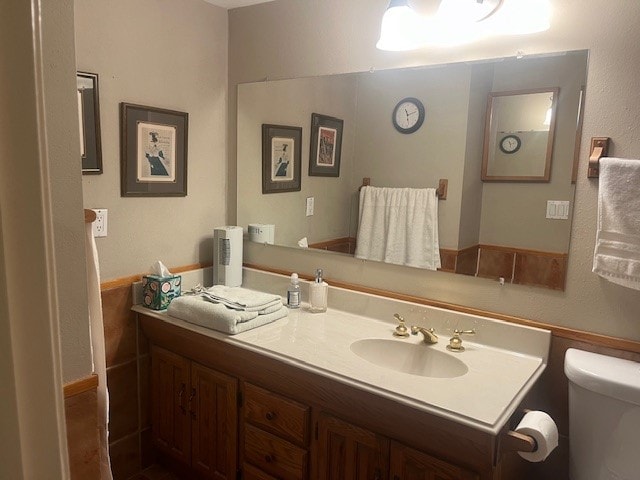 bathroom featuring vanity and toilet