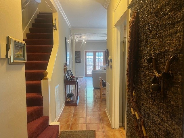 hallway featuring light tile patterned floors and crown molding