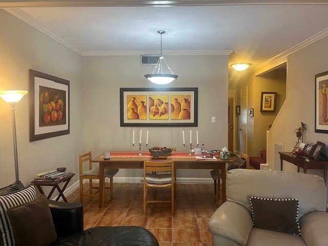 tiled dining room featuring crown molding