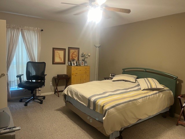 carpeted bedroom with ceiling fan